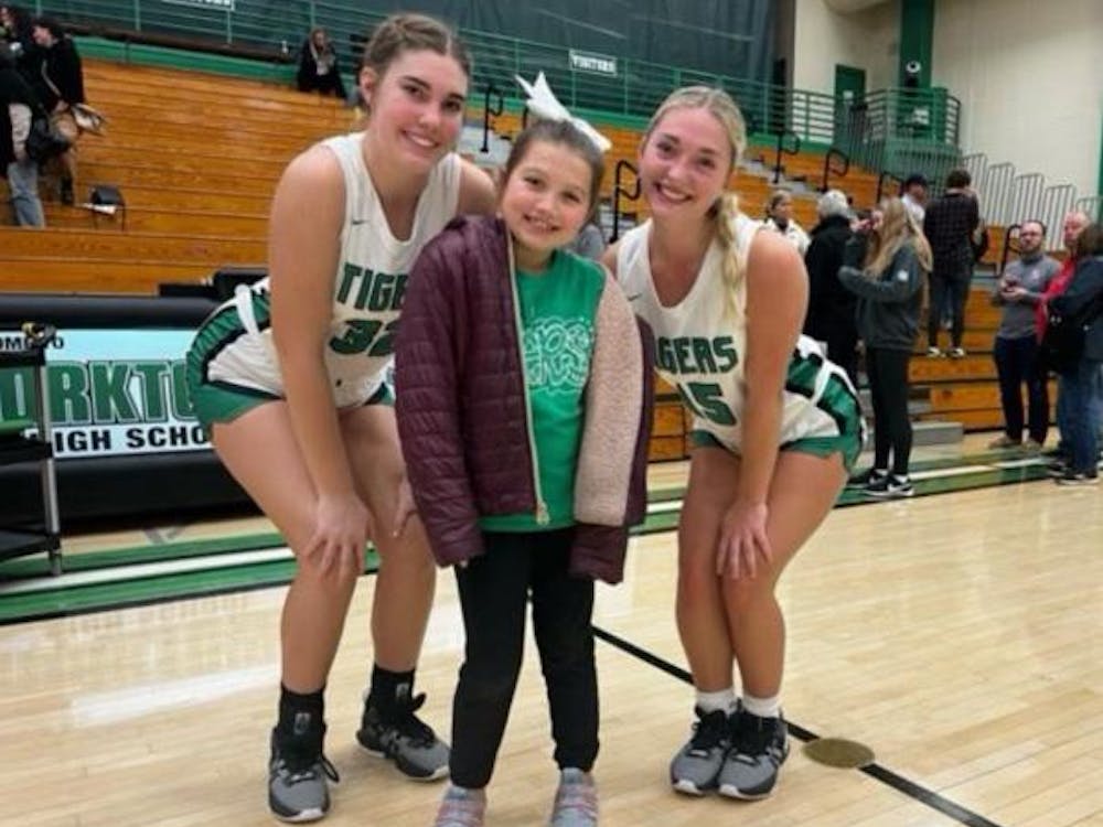 Yorktown freshman Alexis Fields poses with a teammate and a coach's daughter Dec. 5 after a game at Yorktown High School. Alexis Fields, photo provided. 