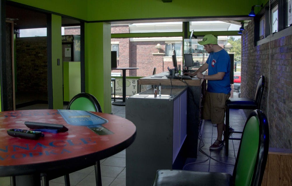 Small Town Vapes in the Village has places to sit, a vape lounge and cases of products. Chronister runs the shop with his brother. DN PHOTO TAYLOR IRBY