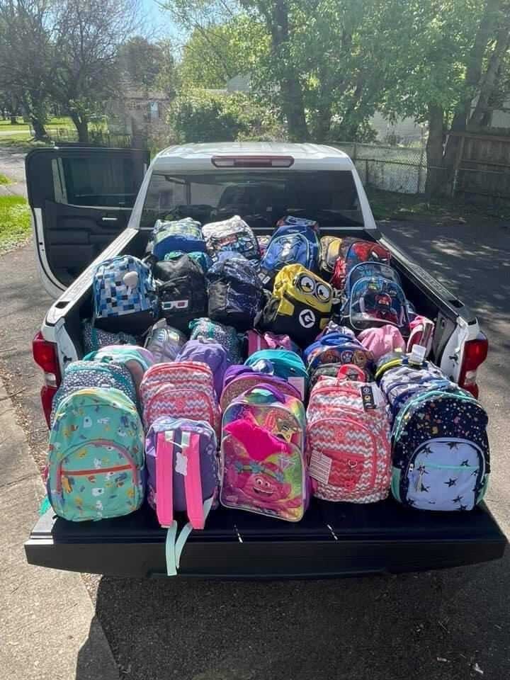 Backpacks filled with clothing and toys sit in the bed of a pickup truck. Turn Away No Longer made 700 backpacks or "SwagPacks" in 2021. Turn Away No Longer, Photo Provided