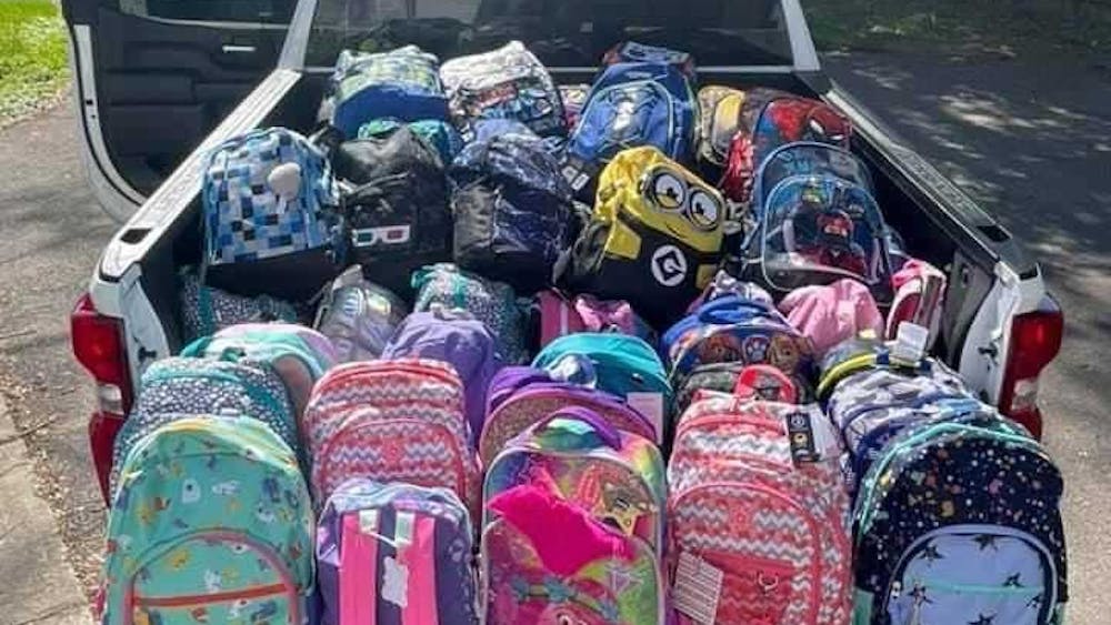 Backpacks filled with clothing and toys sit in the bed of a pickup truck. Turn Away No Longer made 700 backpacks or "SwagPacks" in 2021. Turn Away No Longer, Photo Provided