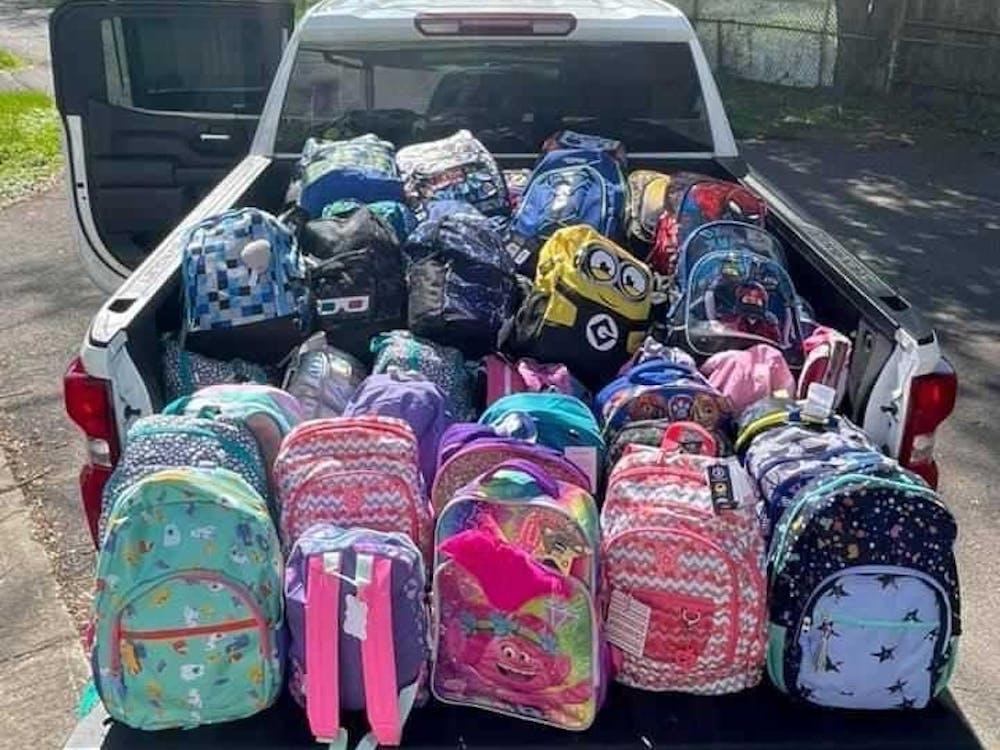 Backpacks filled with clothing and toys sit in the bed of a pickup truck. Turn Away No Longer made 700 backpacks or "SwagPacks" in 2021. Turn Away No Longer, Photo Provided