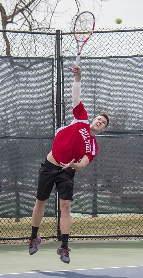 Senior Cliff Morrison serves against Northern Illinois on Apr. 6. DN PHOTO ANDREW KELLY