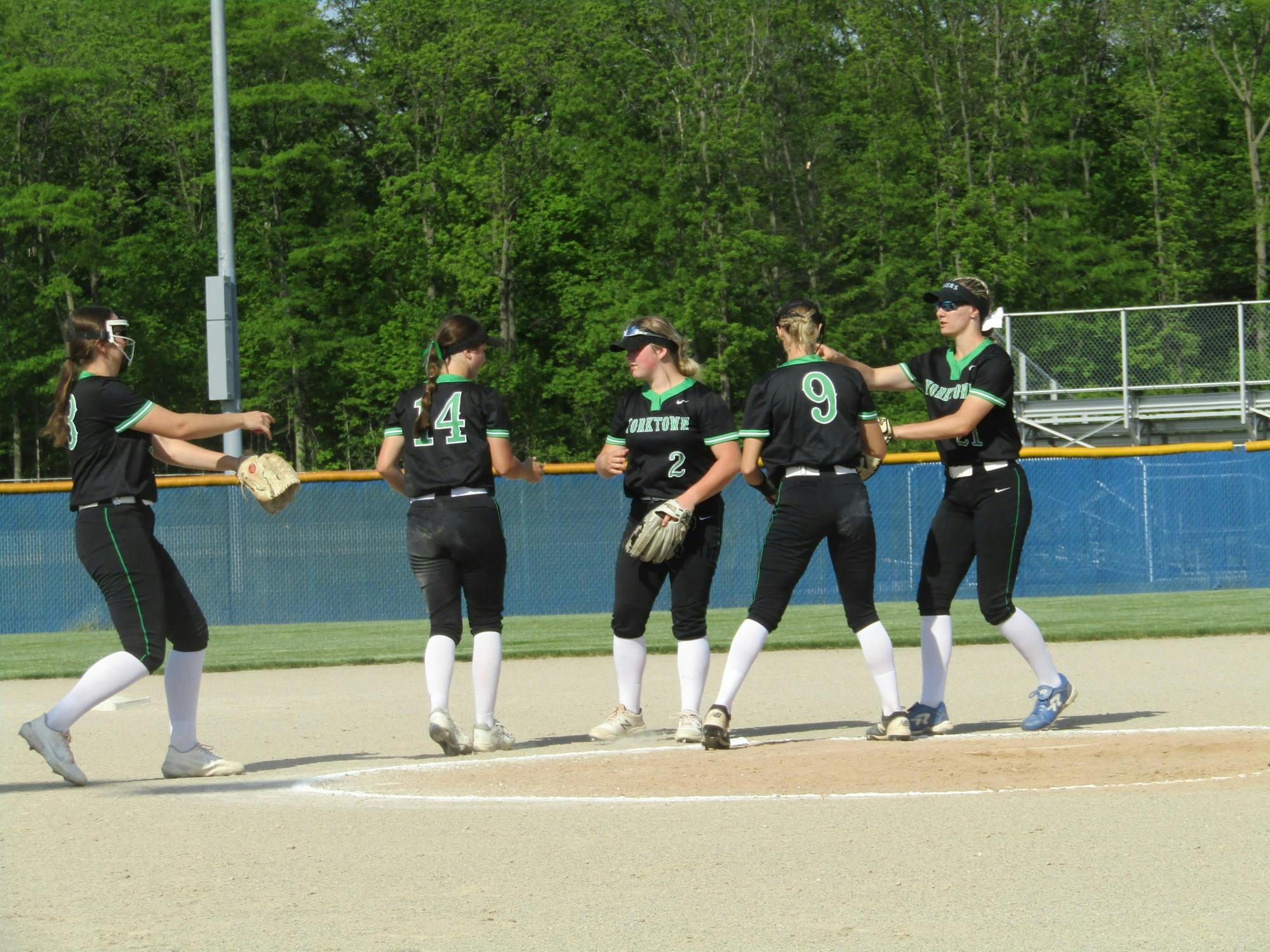 Yorktown High School Softball meets in the pitcher&#x27;s circle, consisting of senior pitcher Alanah Jones, senior first baseman Macie Dowd, junior shortstop Lexy Morris, junior third baseman Jenna Sylvester and sophomore second baseman Ava McNally at Delta High School May 24, 2022. The Tigers defeated Hamilton Heights. (Kyle Smedley/DN)
