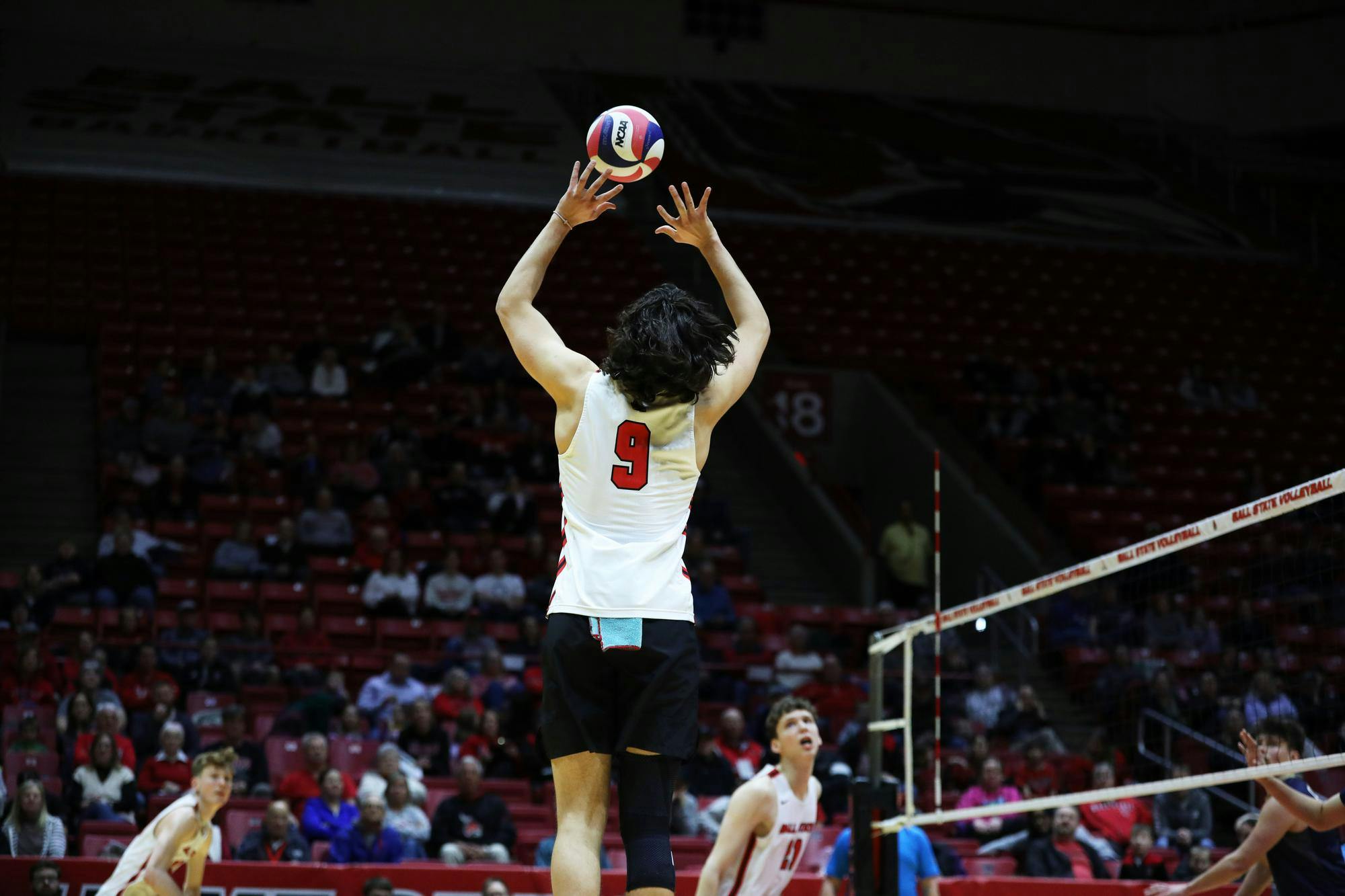 Freshman setter Lucas Machado sets the ball against Queens March 1 at Worthen Arena. Machado scored three points in the game. Mya Cataline, DN