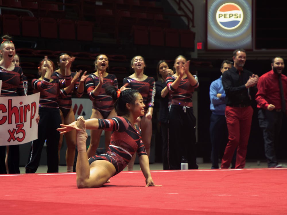 Senior Suki Pfister smiles at the end of her floor routine while the Cardinals cheer for her against Bowling Green Jan. 22 at Worthen Arena. Pfister scored a 9.900 on the floor. Kate Tilbury, DN