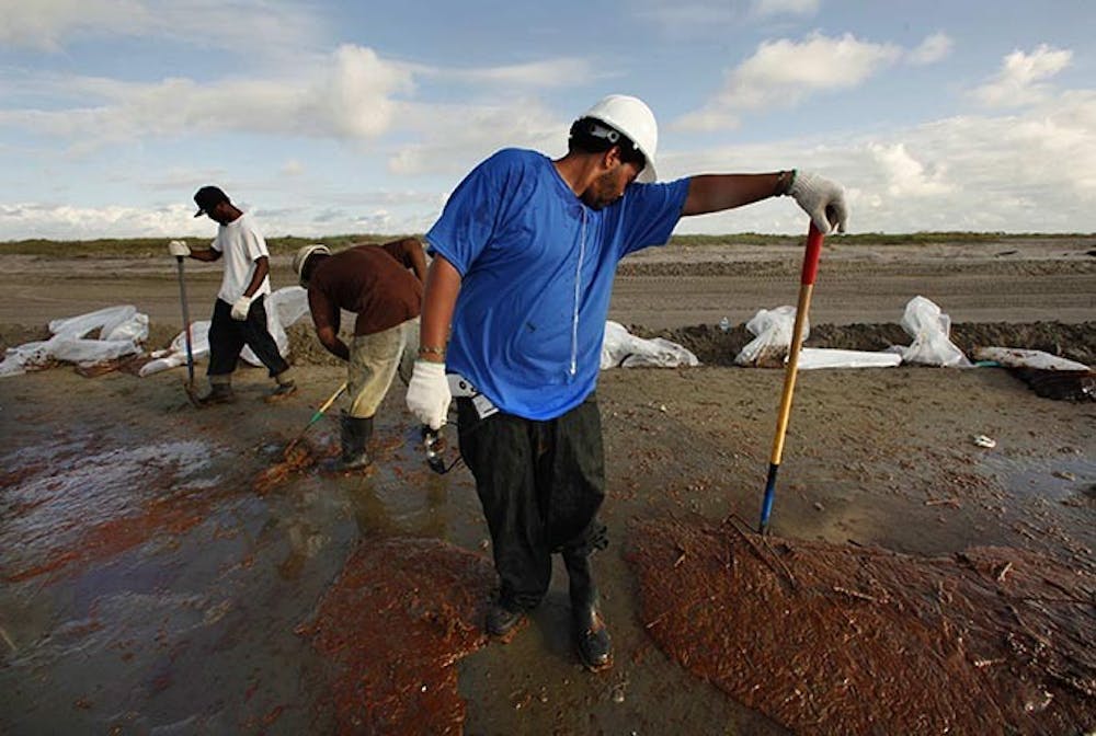 Terrance Castle of Houma, La., works with a crew hired by BP to clean up the oil on a beach near Grand Isle, Louisiana. (Carolyn Cole/Los Angeles Times/MCT)