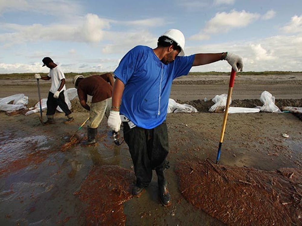 Terrance Castle of Houma, La., works with a crew hired by BP to clean up the oil on a beach near Grand Isle, Louisiana. (Carolyn Cole/Los Angeles Times/MCT)