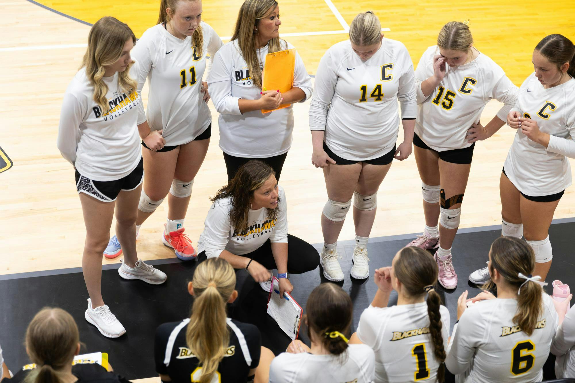 Head Coach Amber Huber talks to the team in between the fourth and fifth sets. The Blackhawks then won the fifth set, giving them their fourth win of the season at Cowan Jr./Sr. High School on Sep.4th. (Photo by Kaylee Kern) 

