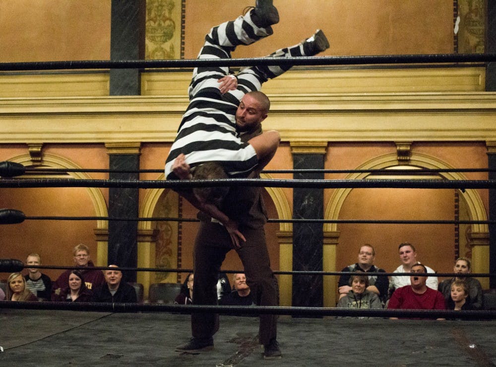 Wrestling character Rep. Gavin Q. Volstead punishes a criminal character with 10 bodyslams during Olde Wrestling's Indiana debut event, A Bonanza of Bodyslams, at Cornerstone Center for the Arts on Nov. 19. The event, which celebrates vintage-style wrestling, aimed to get 50 bodyslams by the end of the night. Grace Ramey // DN