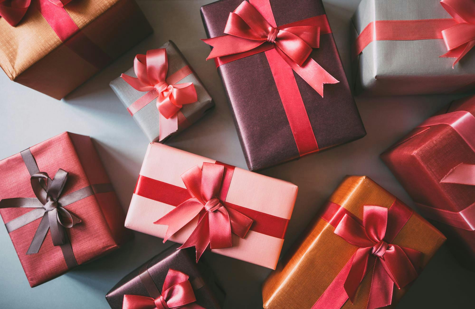 Stylishly packaged boxes with gifts closeup., GettyImages