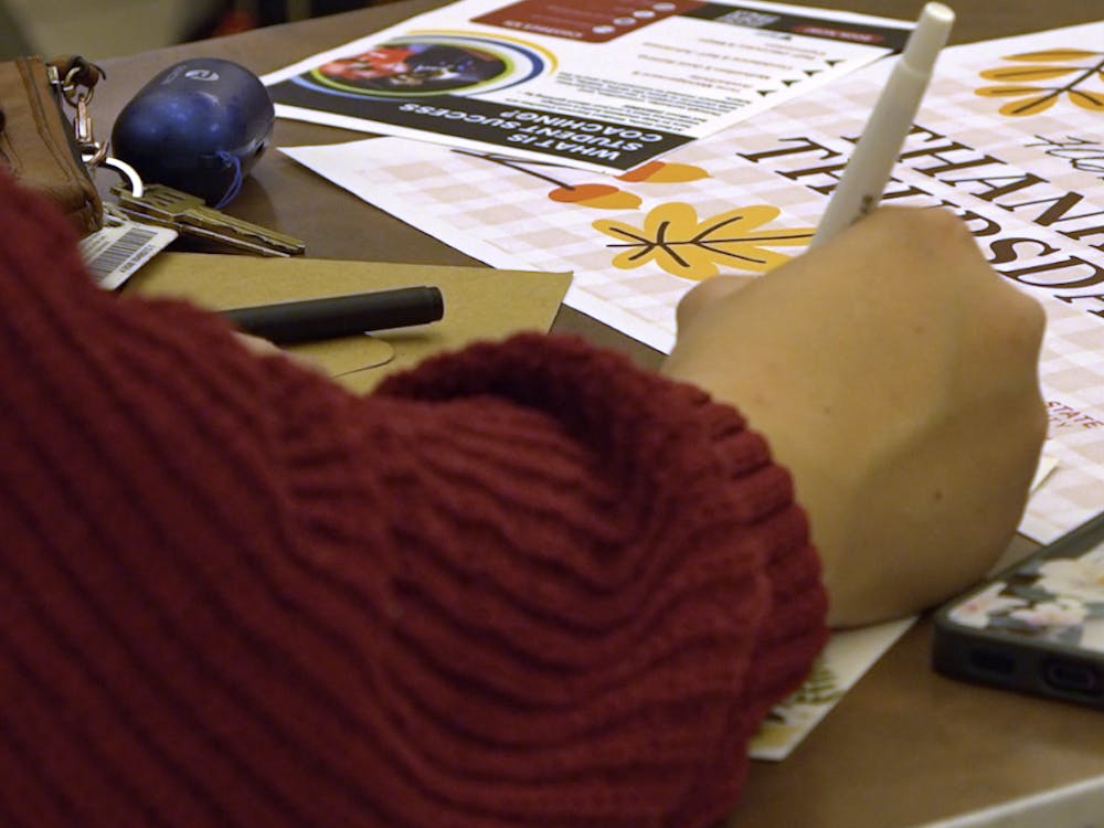 A Ball State student writes a thankful letter at Ball State’s Thankful Thursday event at the Atrium.