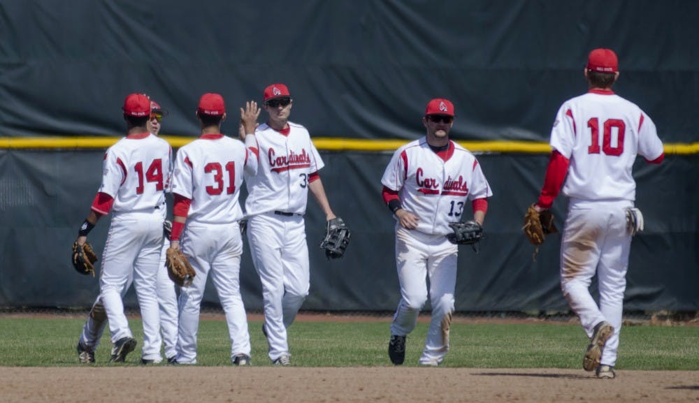The Ball State baseball team high-fives each other after winning 20-5 against Eastern Michigan on April 5 at Ball Diamond. DN PHOTO BREANNA DAUGHERTY 