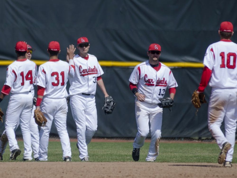 The Ball State baseball team high-fives each other after winning 20-5 against Eastern Michigan on April 5 at Ball Diamond. DN PHOTO BREANNA DAUGHERTY 