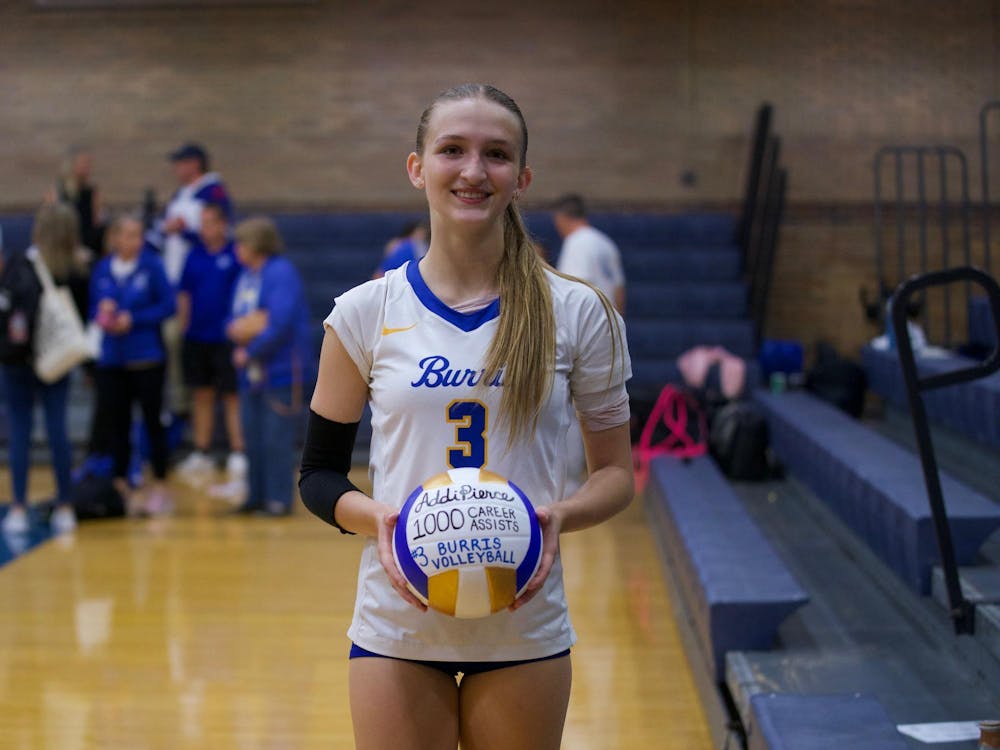 Burris setter and opposite hitter Addi Pierce (#3) smiles while holding a commemorative ball after recording her 1,000th career assist. As she helped lead the Owls to a 3-0 straight set victory against Wapahani. PHOTO BY BRODRICK GOOD