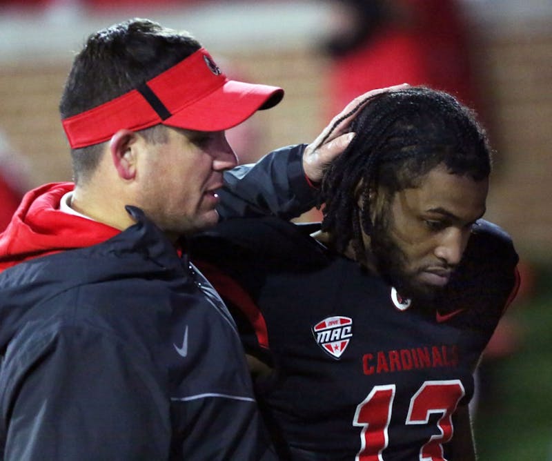 Redshirt senior cornerback David Moore gets a hug from a coach after the Cardinals’ game against Miami Ohio on Nov. 21 at Scheumann Stadium. Ball State lost 7 to 28 on senior night. Paige Grider, DN