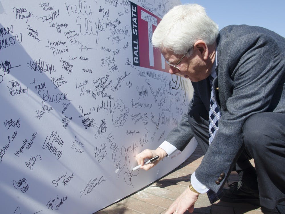 Ball State President Paul Ferguson signs the poster at the THAD Days on Oct. 8 at the Scramble Light. DN PHOTO BREANNA DAUGHERTY