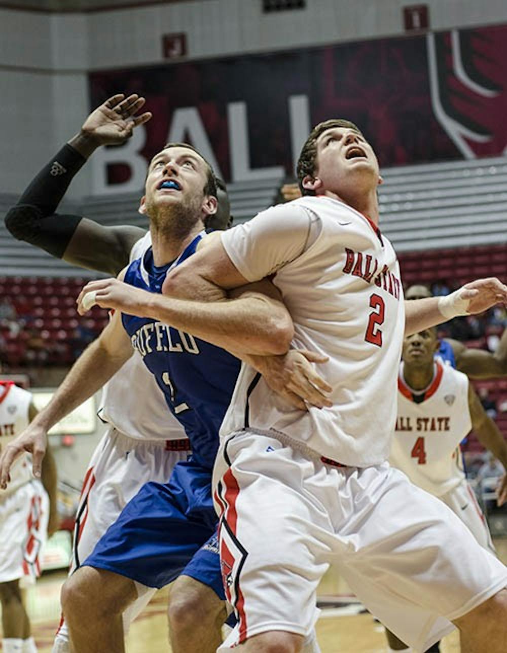 Ball State’s Matt Kamieniecki and Buffalo’s Will Regan wait for the rebound after Ball State misses a shot in the game against Buffalo on Jan. 23, 2013. Kamieniecki almost chose Western Michigan over Ball State. DN FILE PHOTO COREY OHLENKAMP
