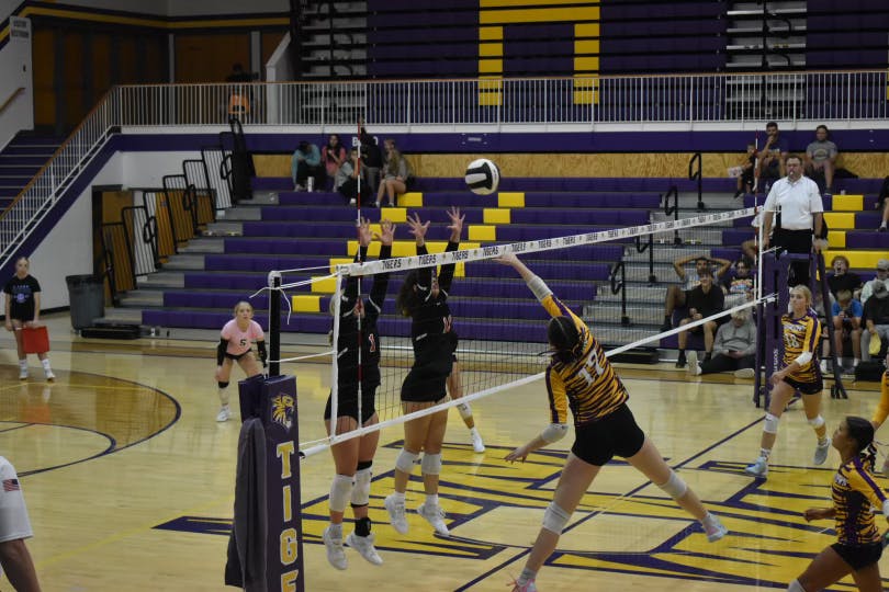 Tatum Dudley (#1) and Olivia Walters (#11) go up to block, taking down the tigers in a 3-0 sweep. Photo by Kenna Geibel 
