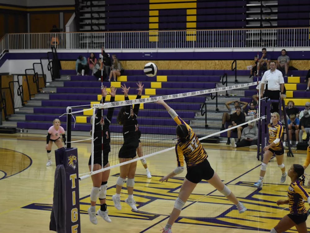 Tatum Dudley (#1) and Olivia Walters (#11) go up to block, taking down the tigers in a 3-0 sweep. Photo by Kenna Geibel