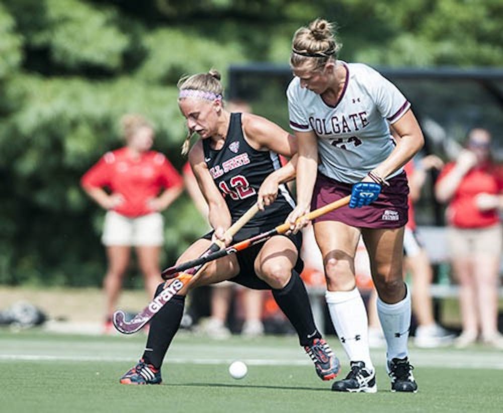 Ball State junior Tarel Teach attempts to push back Colgate senior Kelsey Jensen to receive a pass. Teach scored both goals in Ball State’s 2-1 win against Colgate. DN PHOTO JONATHAN MIKSANEK