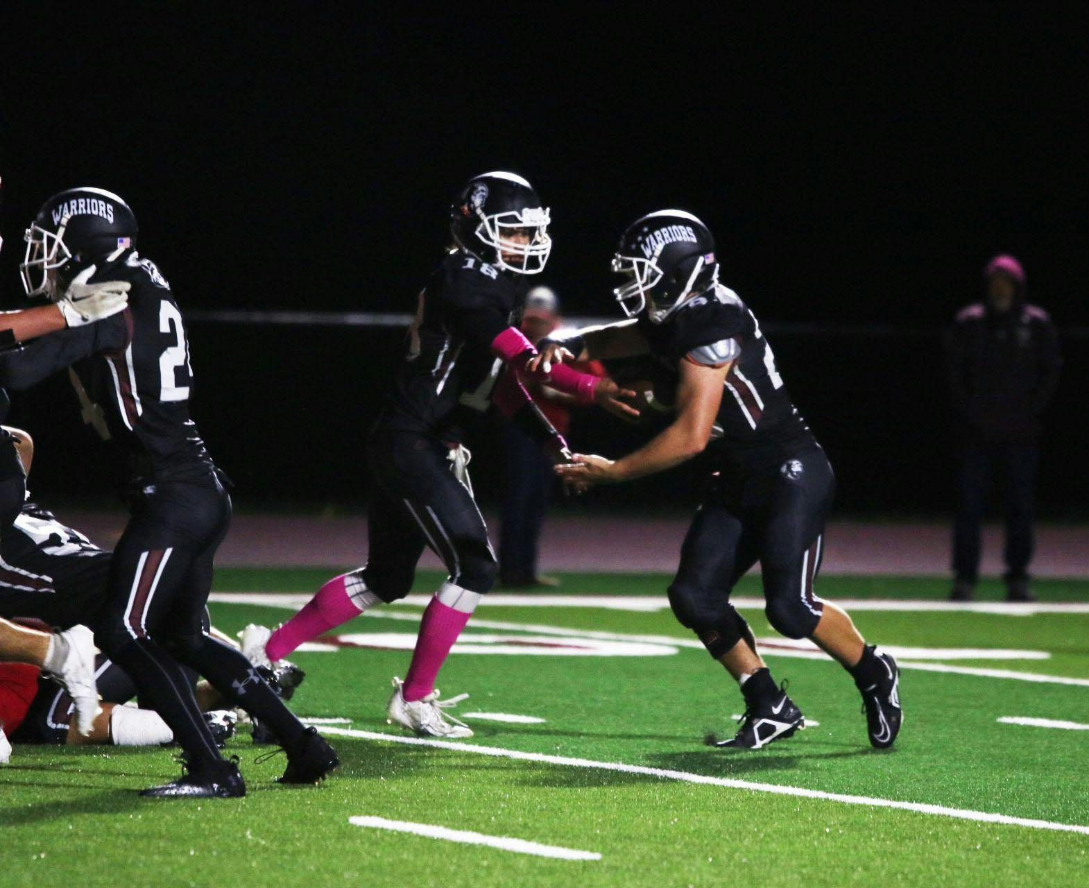 Wes-Del senior Triton Blevins hands the ball off Oct. 7 in a game against Union County. Zach Carter, DN.