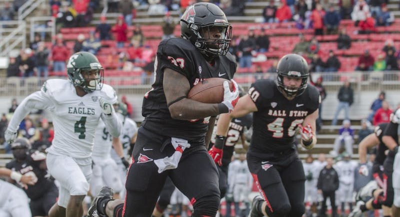 Senior running back Jahwan Edwards runs the ball down the field during the game against Eastern Michigan on Nov. 22 at Scheumann Stadium. DN PHOTO BREANNA DAUGHERTY