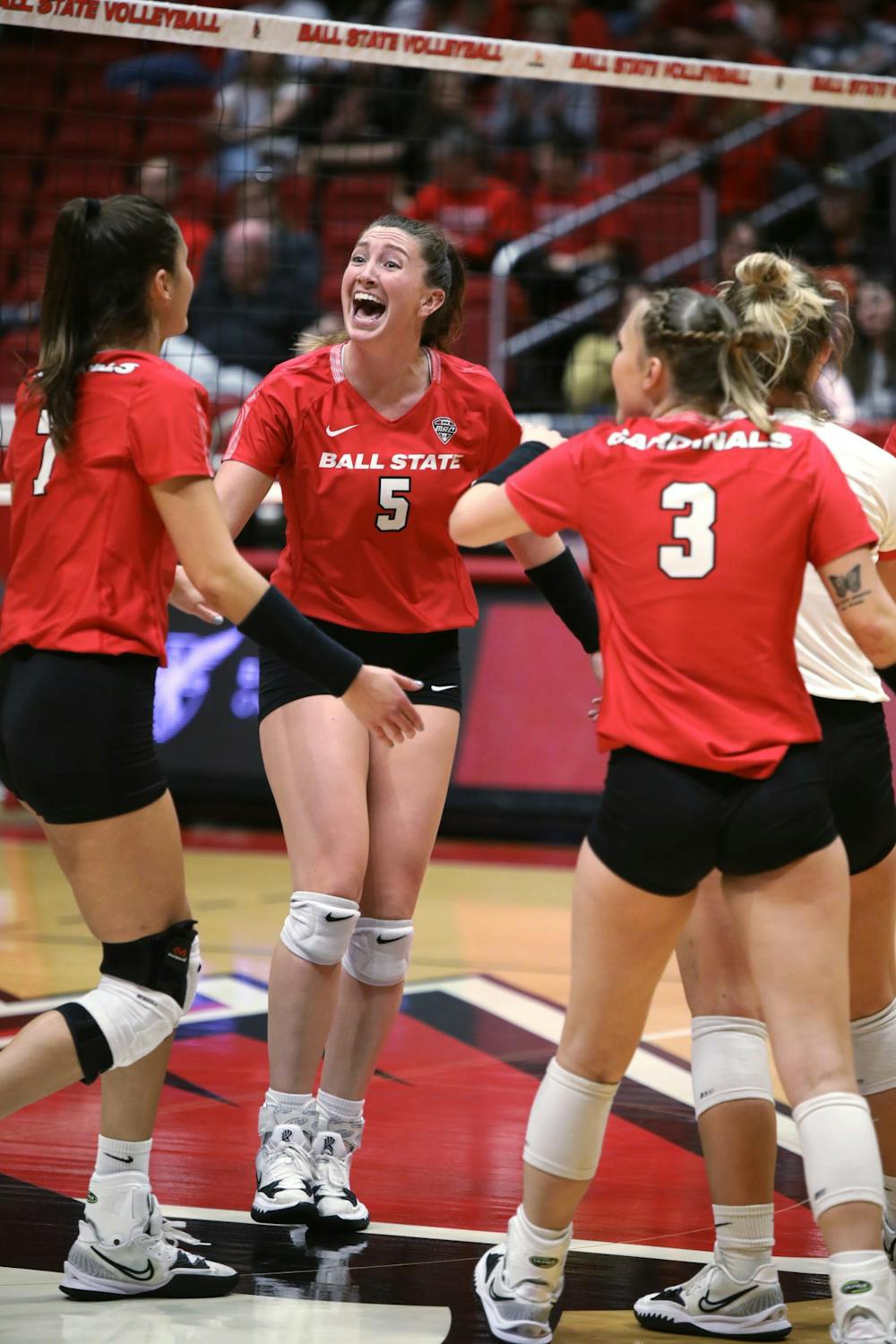 Fourth-year middle blocker Marie Plitt celebrates fourth-year outside hitter Natalie Risi scoring a point in a game against Eastern Michigan Sept. 30 at Worthen Arena. Ball State beat Eastern Michigan 3-1. Amber Pietz, DN