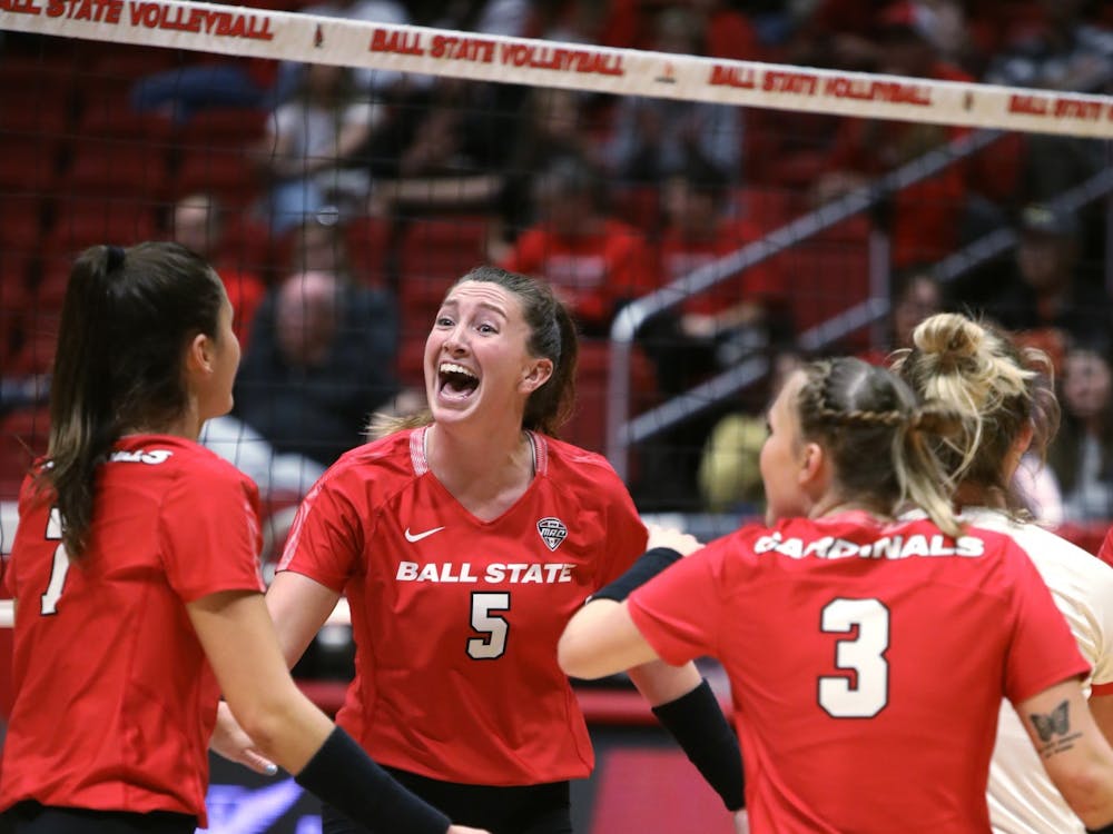 Fourth-year middle blocker Marie Plitt celebrates fourth-year outside hitter Natalie Risi scoring a point in a game against Eastern Michigan Sept. 30 at Worthen Arena. Ball State beat Eastern Michigan 3-1. Amber Pietz, DN