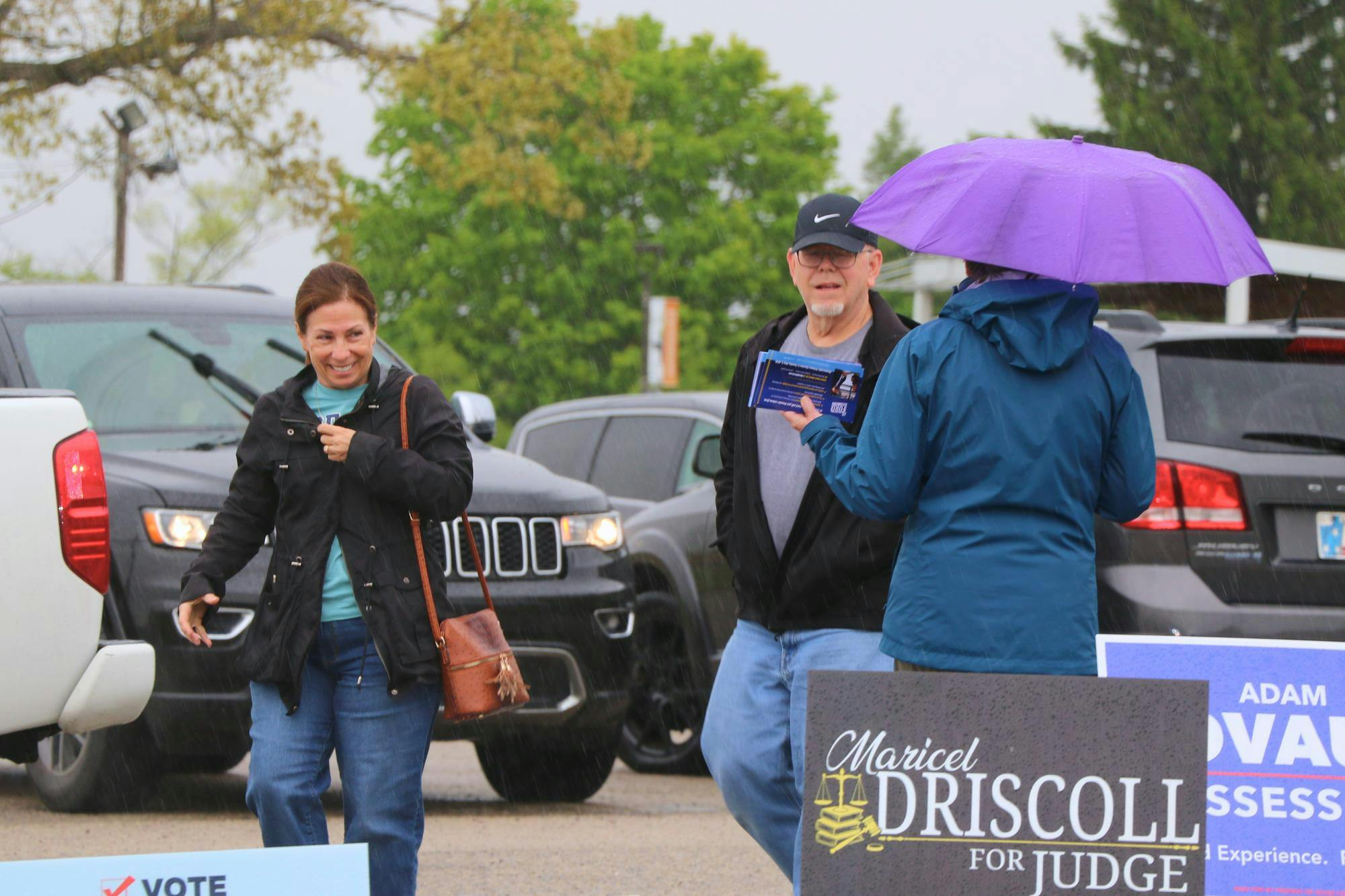 Residents walking past a candidate into a voting center on Election Day. Cameron Noe, DN.