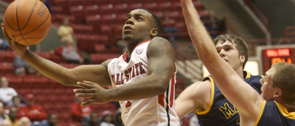 Ball State freshman Zavier Turner drives past Marian defenders at Worthern Arena Nov. 4. Turner led the Cardinals with 18 ponts for the night. DN PHOTO MARCEY BURTON