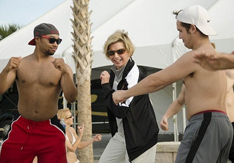 Ball State University President Jo Ann Gora dances with Ball State fans after an afternoon of competition between the Ball State Pride of Mid-America Marching Band and the University of Central Florida Marching Knights. DN PHOTO COREY OHLENKAMP