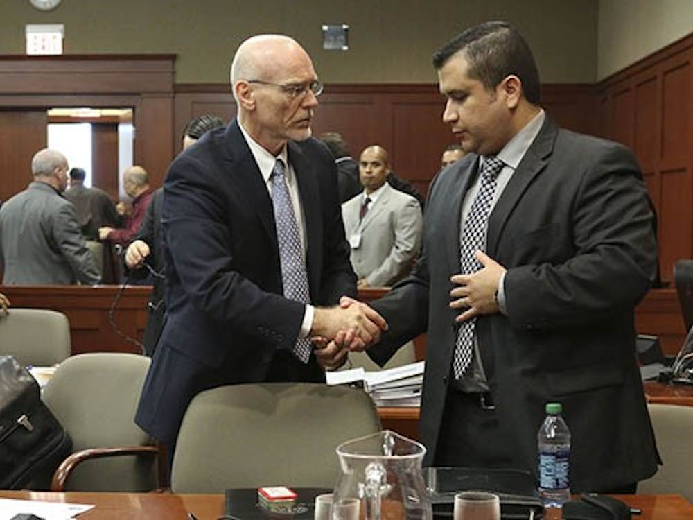 George Zimmerman shakes hands with defense attorney Don West during Zimmerman's trial in Seminole circuit court, in Sanford, Florida, Wednesday. Zimmerman is charged with second-degree murder in the fatal shooting of Trayvon Martin in 2012. MCT PHOTO 