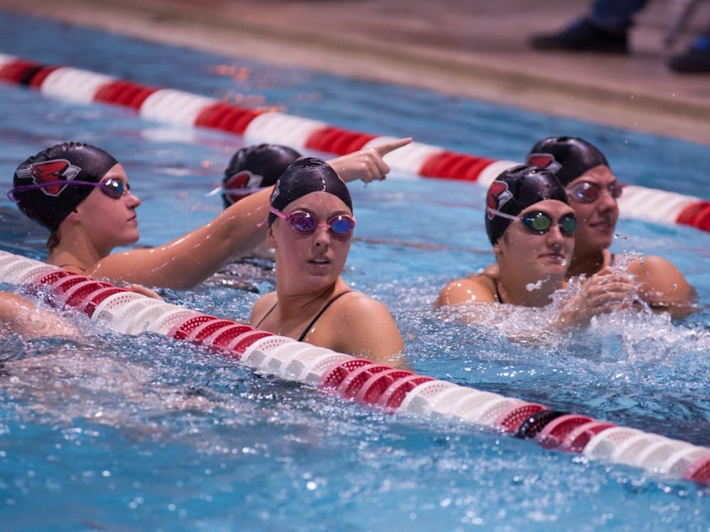 A group of Ball State swimmers talk in one of the lanes during a break at the 10th annual Doug Coers Invitational at Lewellen Aquatic Center. DN PHOTO KATIE GRAY