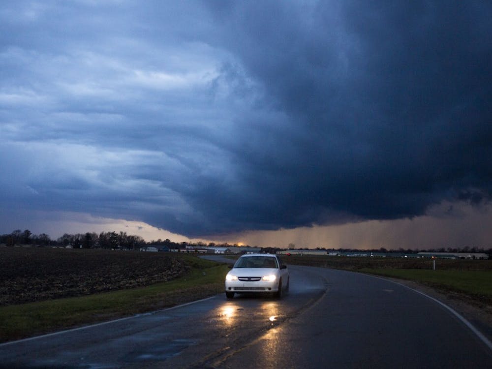 A car drives through the rain on East Riggin Road during a thunderstorm warning Nov. 17 in Muncie. Storms in East Central Indiana left heavy damage in southern Kokomo, which prompted the city to declare a state of emergency. DN PHOTO TAYLOR IRBY