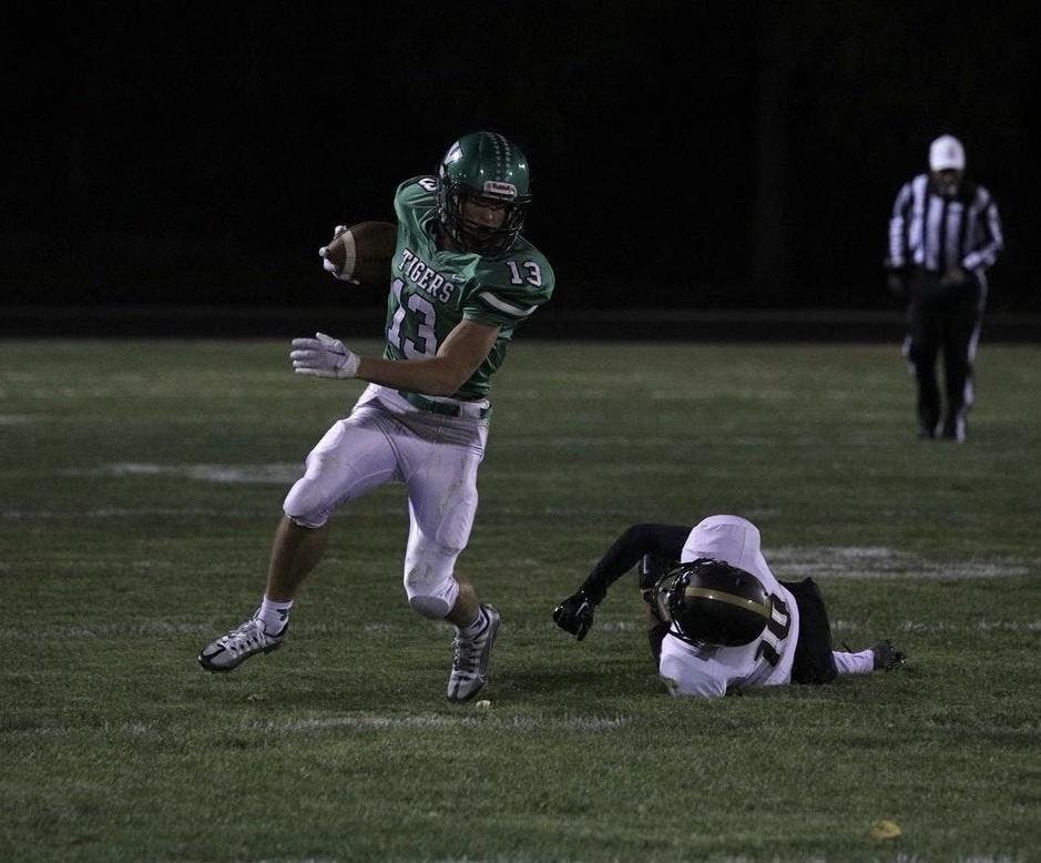 Yorktown senior Kolton Nanko takes off after an unuccessful tackle by Mount Vernon on Oct. 14 at Tiger Stadium in Yorktown, Indiana. Nanko would be named Zach Carter's Boys Athlete of the Year. Brayden Goins, DN