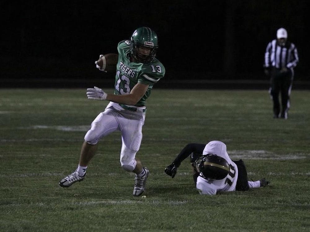 Yorktown senior Kolton Nanko takes off after an unuccessful tackle by Mount Vernon on Oct. 14 at Tiger Stadium in Yorktown, Indiana. Nanko would be named Zach Carter's Boys Athlete of the Year. Brayden Goins, DN