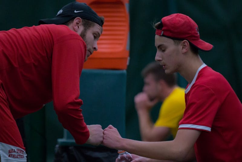 Graduate Assistant Lucas Andersen talks with Chris Adams between tennis matches against the University of Toledo. Ball State won 5 to 2 on March 24 at Northwest YMCA in Muncie. Eric Pritchett, DN