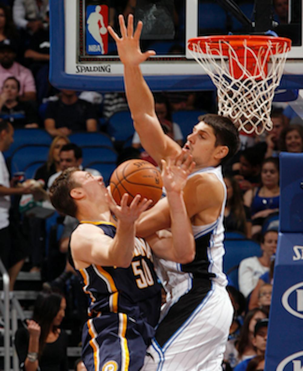 MCT PHOTO Orlando Magic forward Nikola Vucevic fouls Indiana Pacers forward Tyler Hansbrough in the paint during the second half of preseason action Oct. 19 at the Amway Center in Orlando, Fla. Indiana defeated Toronto 90-88 on Wednesday. 