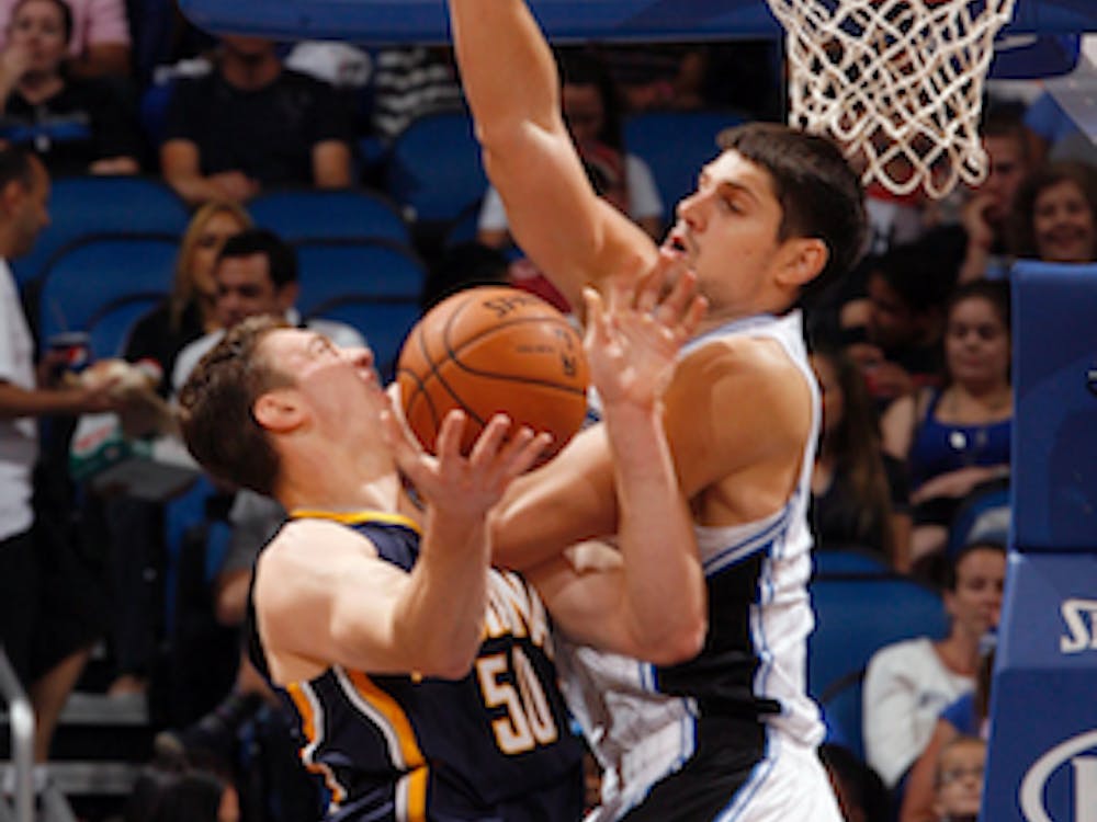 MCT PHOTO Orlando Magic forward Nikola Vucevic fouls Indiana Pacers forward Tyler Hansbrough in the paint during the second half of preseason action Oct. 19 at the Amway Center in Orlando, Fla. Indiana defeated Toronto 90-88 on Wednesday. 