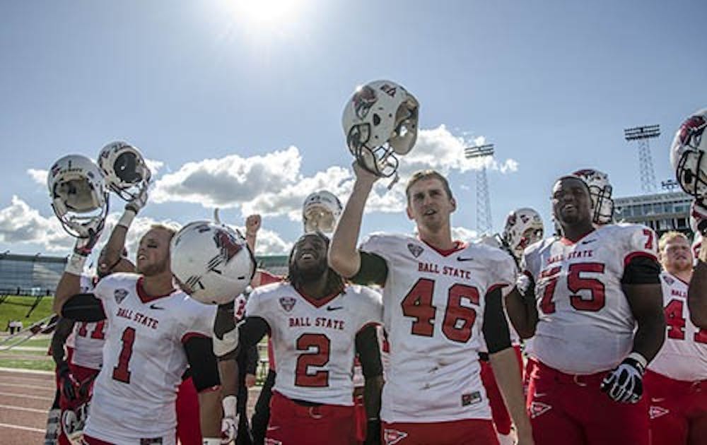 Ball State football players celebrate a victory against Eastern Michigan University by singing Ball State's Alma Mater. Ball State's win gave it a 3-1 record. DN PHOTO COREY OHLENKAMP