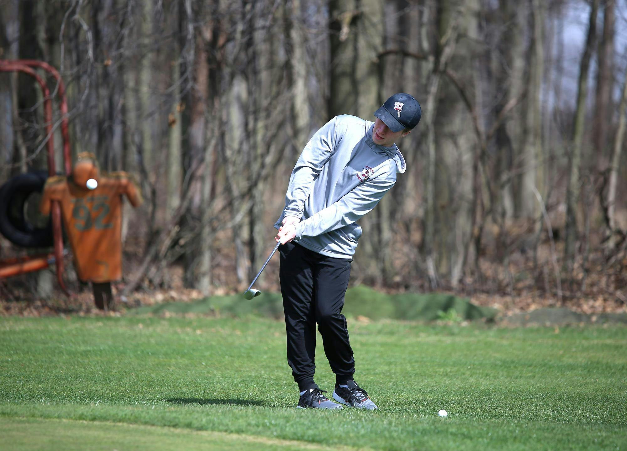 Wes-Del junior Grayden Hensley chips the ball March 19 at the school's new practice green at Wes-Del Junior/ Senior High School. Zach Carter, DN