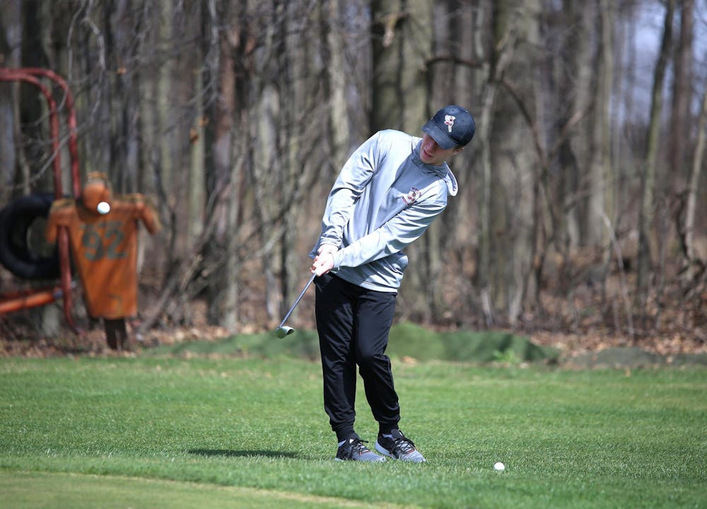 <p>Wes-Del junior Grayden Hensley chips the ball March 19 at the school's new practice green at Wes-Del Junior/ Senior High School. Zach Carter, DN</p>