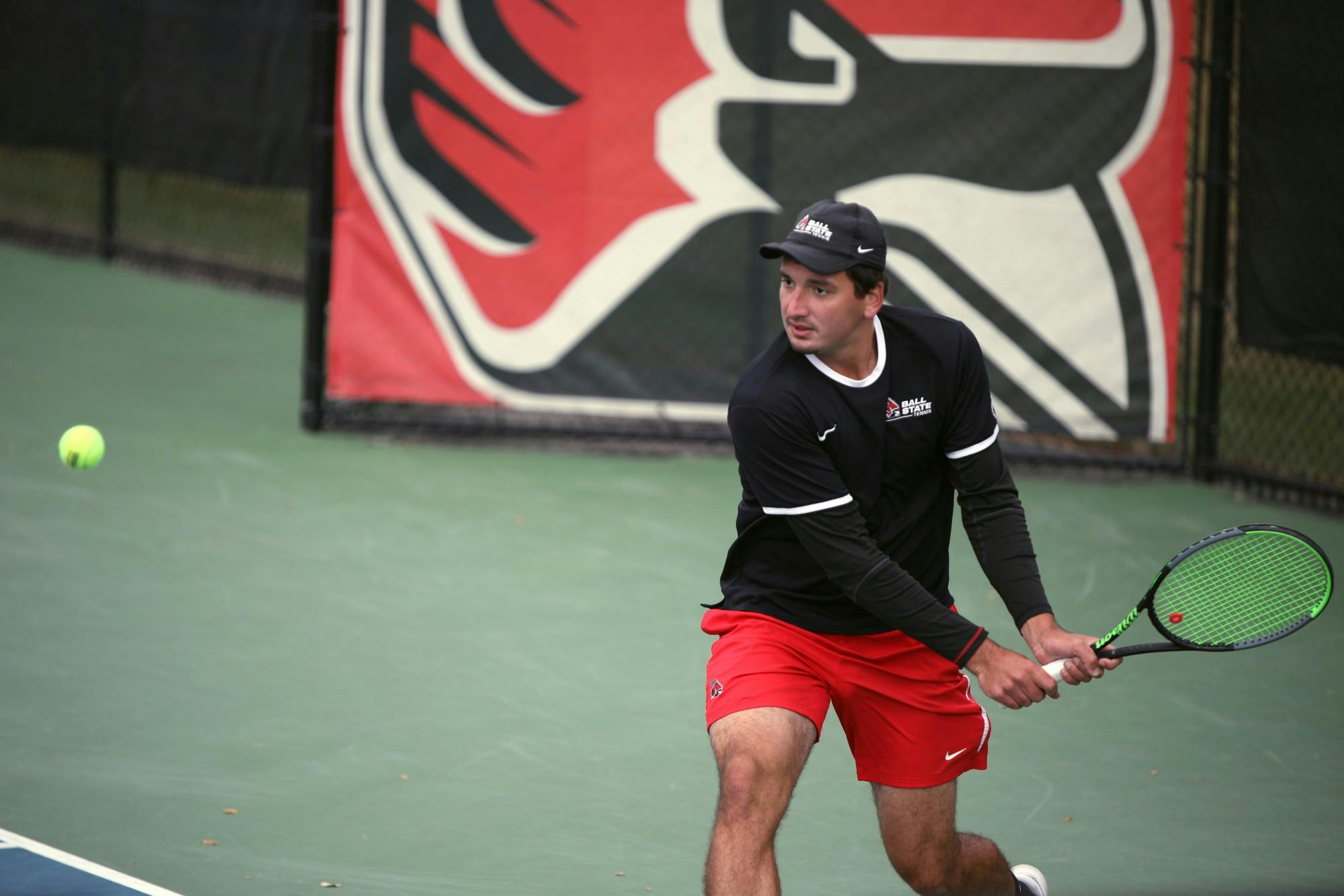 Graduate student Danilo Kovacevic hits the ball in a doubles match with fourth-year Parrish Simmons against Marquette Oct. 7 at Cardinal Creek Tennis Center. Kovacevic and Simmons beat Marquette 7-5. Amber Pietz, DN