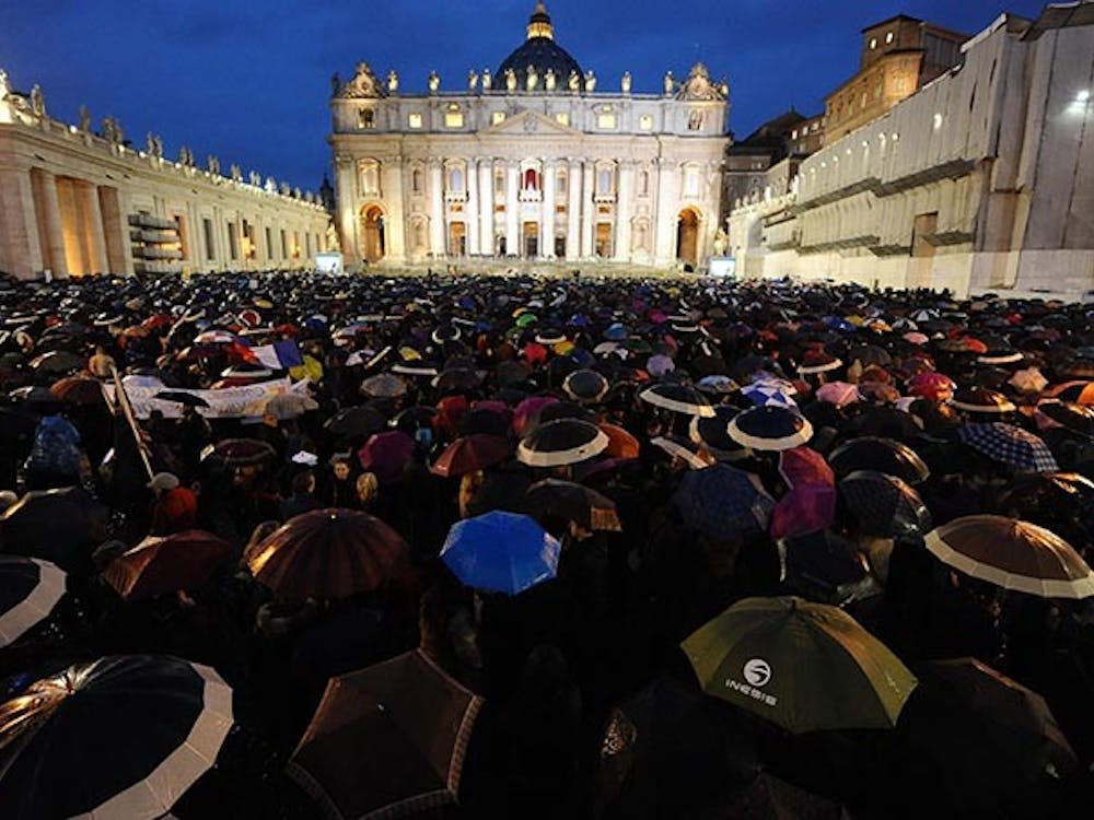 Faithfuls wait under rain at St. Peter&apos;s Square for the smoke announcing the result on the second day of the papal election conclave, Wednesday, March 13, 2013, at the Vatican. (Ansa/Zuma Press/MCT)