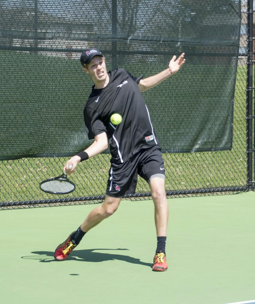 Sophomore Lucas Anderson hits the ball during the match against Western Michigan on April 11 at Cardinal Creek Tennis Courts. DN PHOTO ALAINA JAYE HALSEY