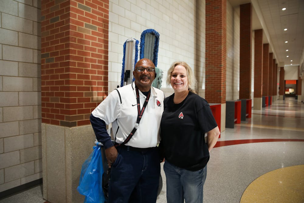 Field facilities attendants Billy D. Harris Sr. (left) and Connie Lent (right) pose for a photo in the Jo Ann Gora Recreation and Wellness Center April 12. Jacy Bradley, DN