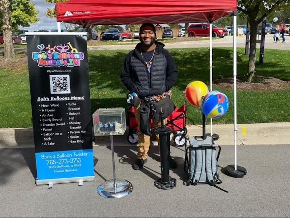 
​
Poe, Elijah
​
Schaivon Nevings poses for a photo at the Farmer's Market at Minnetrista Museum and Gardens, where he often sells his balloon creations. Nevings creates balloon designs for kid and adult parties and community events.