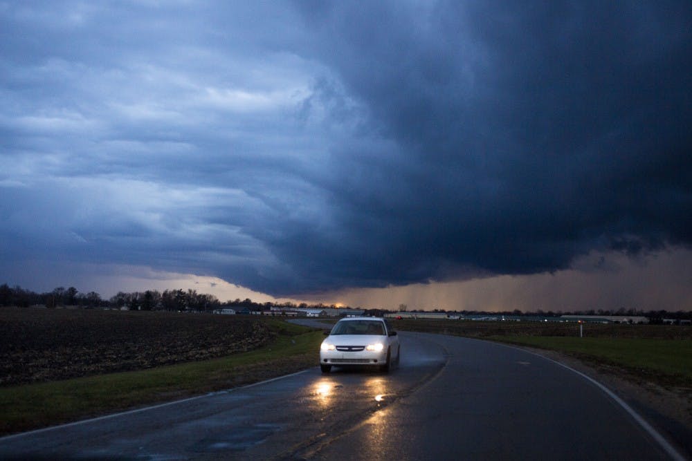 A car drives through the rain on East Riggin Road during a thunderstorm warning Nov. 17 in Muncie. Storms in East Central Indiana left heavy damage in southern Kokomo, which prompted the city to declare a state of emergency. DN PHOTO TAYLOR IRBY