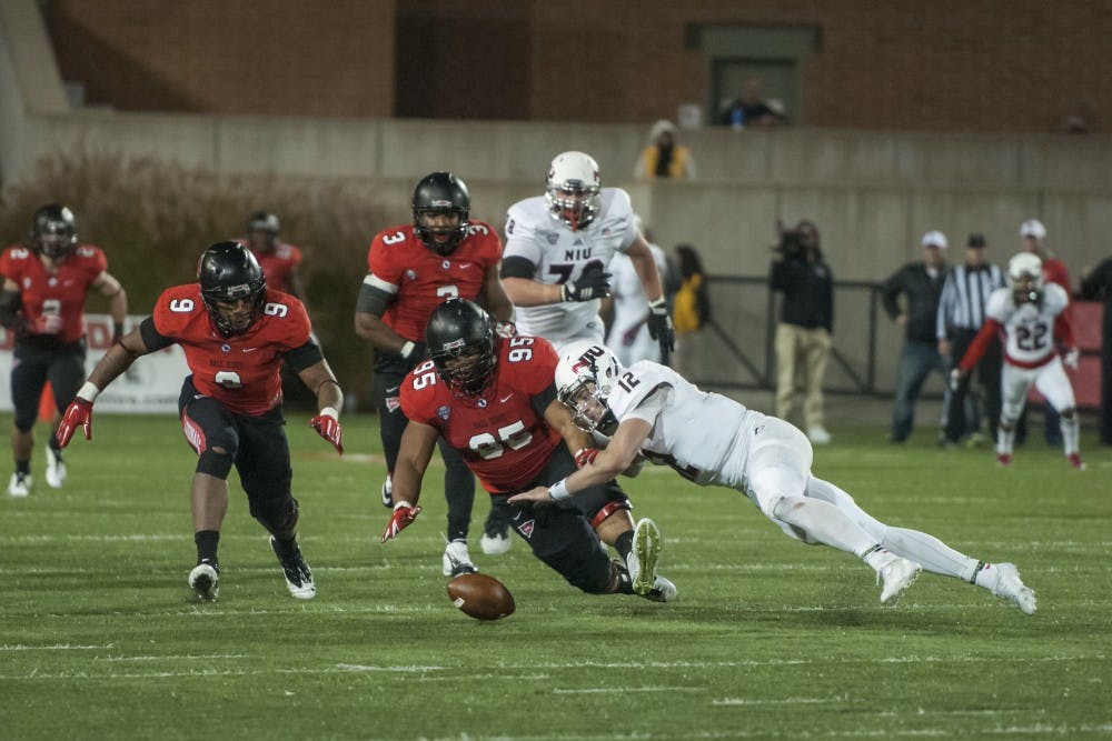 Both teams go after a fumble during the game against Northern Illinois on Nov. 5 at Scheumann Stadium. DN PHOTO JONATHAN MIKSANEK