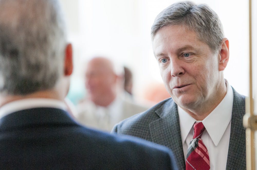 Bill Scholl, Ball State's athletic director, talks with press and other members after the GoDaddy Bowl press conference Jan. 3 at the Mobile Convention Center in Mobile, Ala. DN PHOTO JONATHAN MIKSANEK